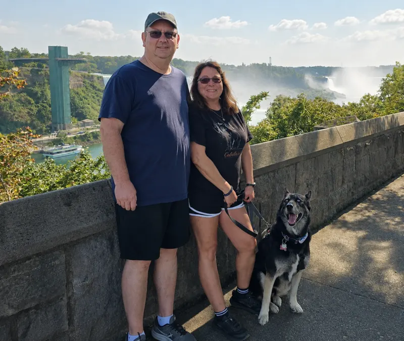 Jazmine standing with her family at a scenic overlook near Niagara Falls.